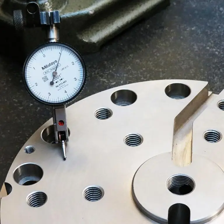Dial indicator inspecting a machined part