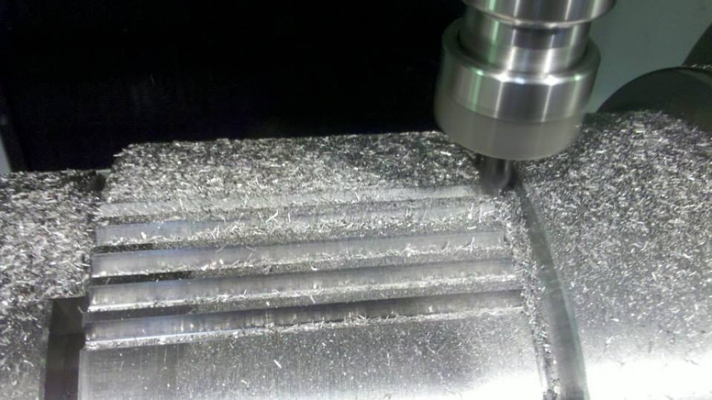 CNC mill cutting grooves in a steel part