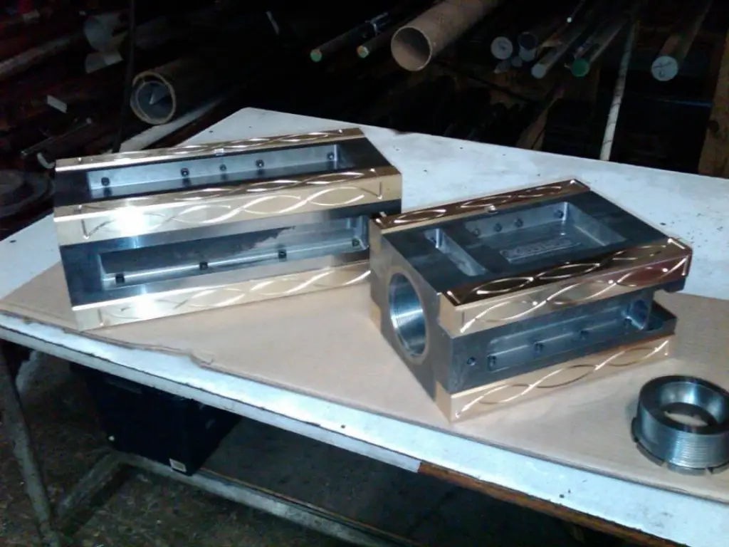 Finished machined mold blocks on a bench