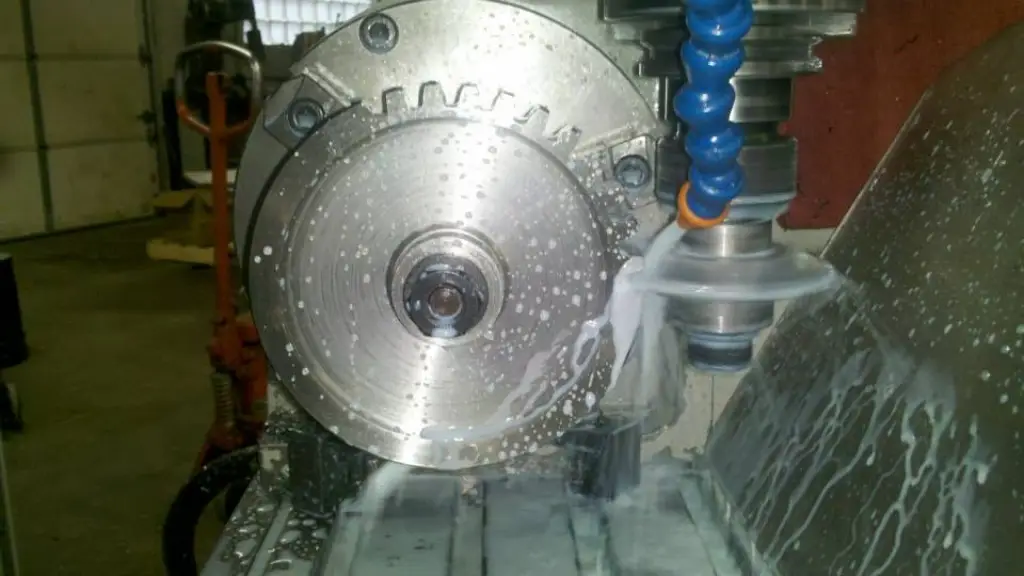 Part on a rotary table being milled with coolant