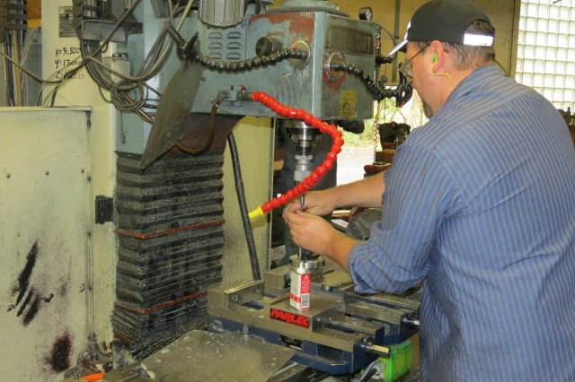 Machinist working at a manual vertical mill
