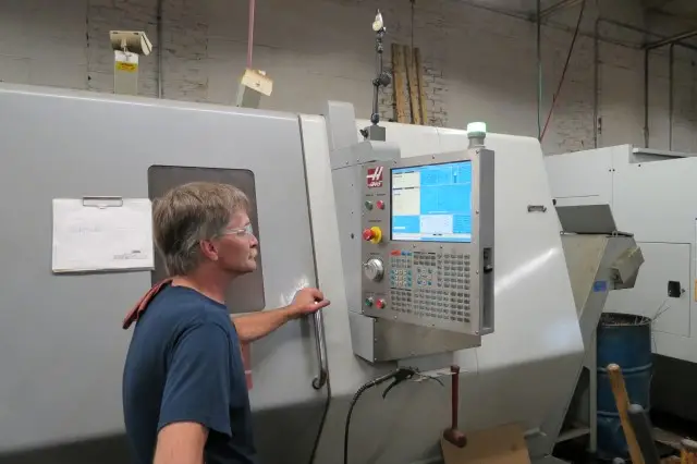 Machinist running a HAAS CNC lathe