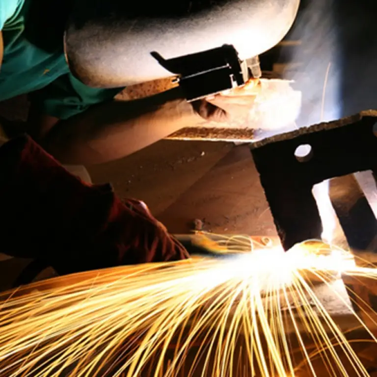 Welder at work with sparks flying